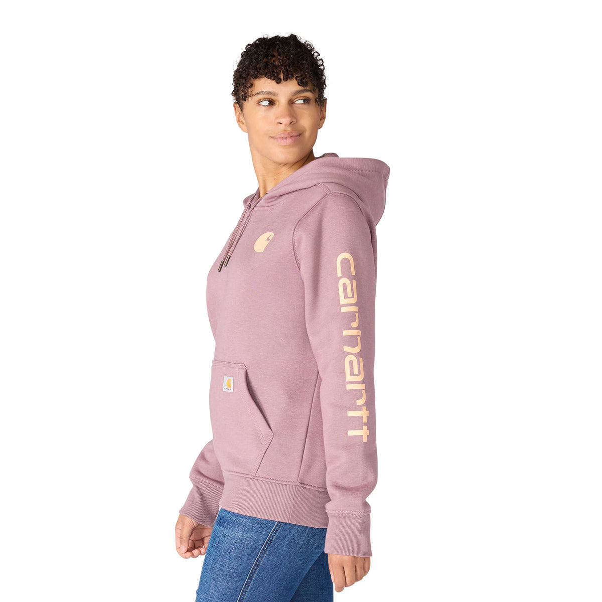 Person wearing a pink hoodie with 'Carhartt' branding on a white background