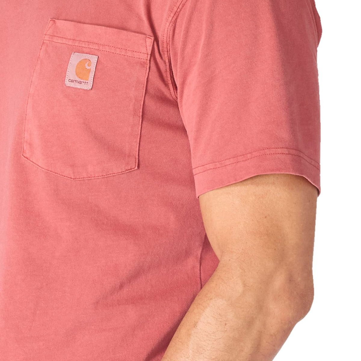 Close-up of a pink t-shirt with a brand logo on a white background