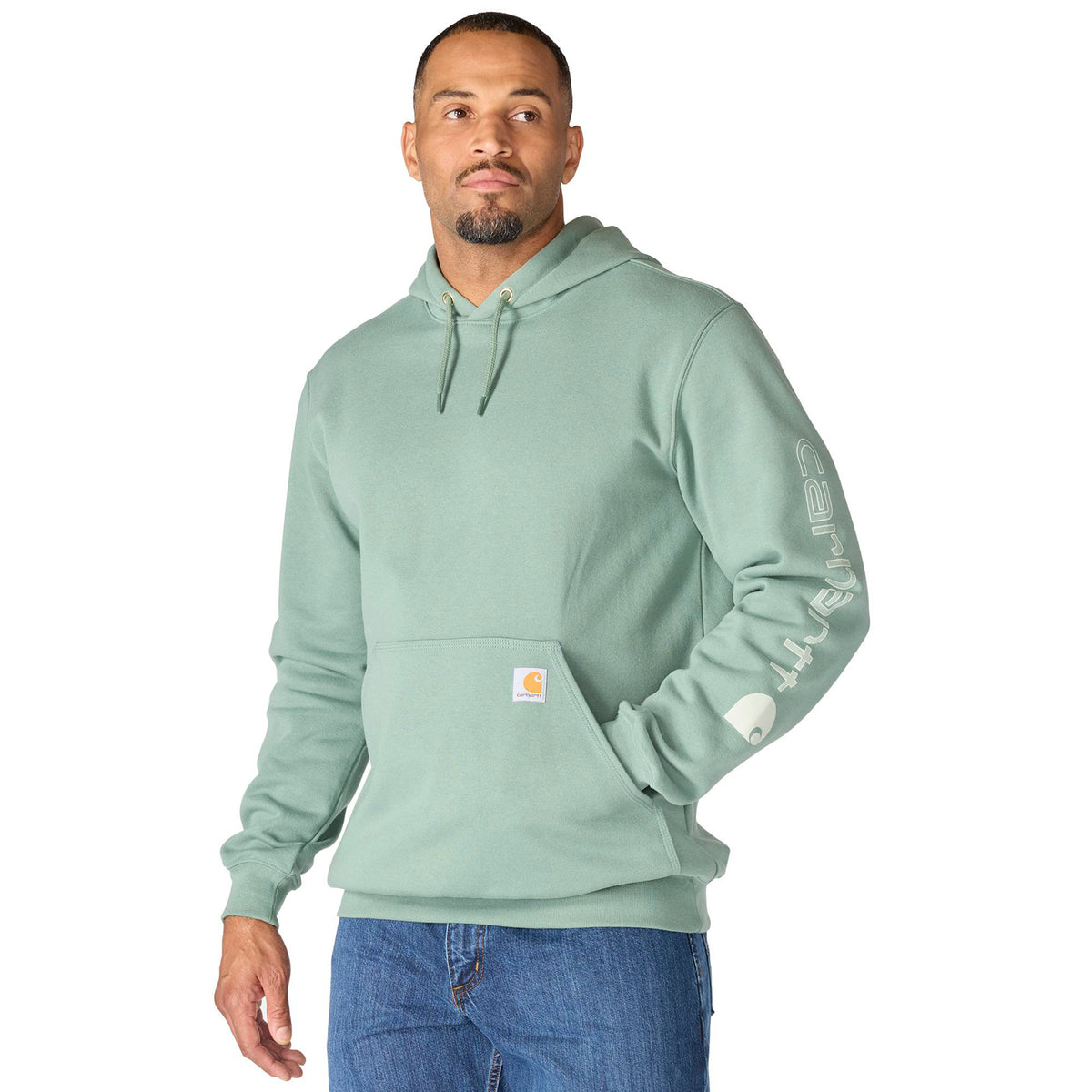 Man wearing a light green hoodie with a visible brand logo on a white background