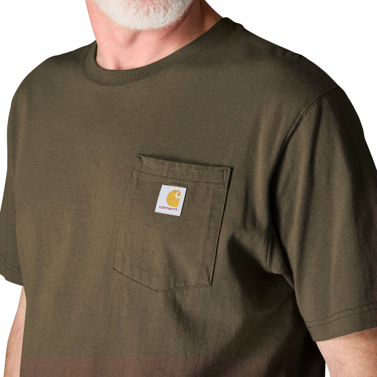 Man wearing a green t-shirt with a visible brand logo on a white background