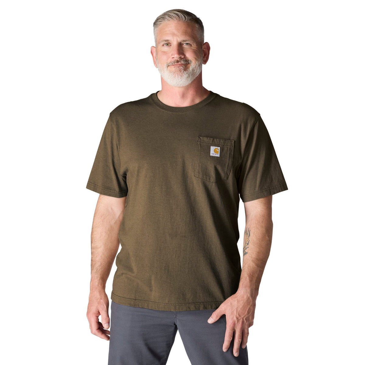 Man wearing a brown t-shirt with a visible brand logo on a white background