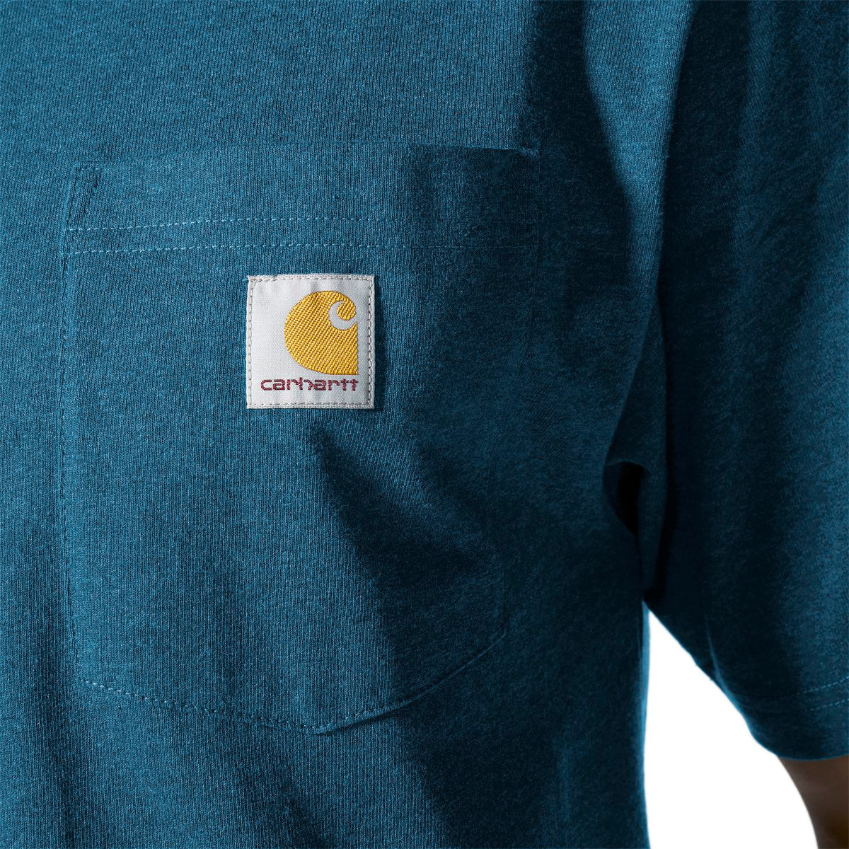 Close-up of a blue shirt with Carhartt logo on a white background