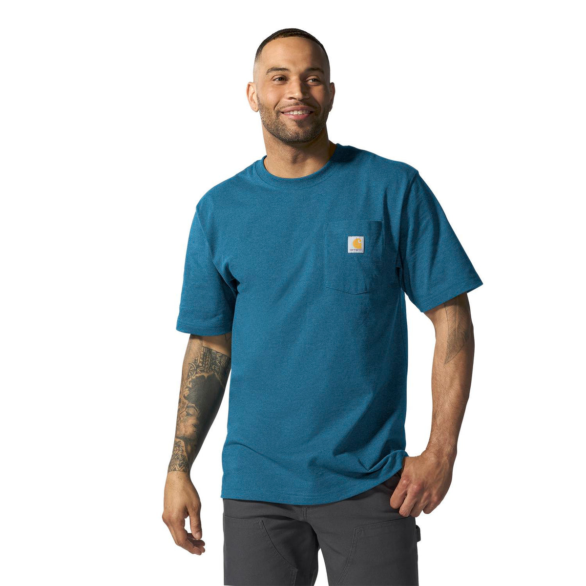 Man wearing a blue t-shirt with a visible brand logo on a white background