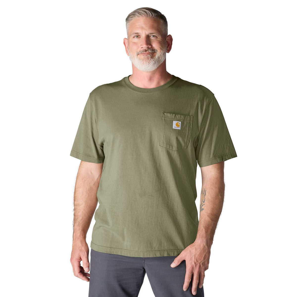 Man wearing a green t-shirt with a Carhartt logo on a white background