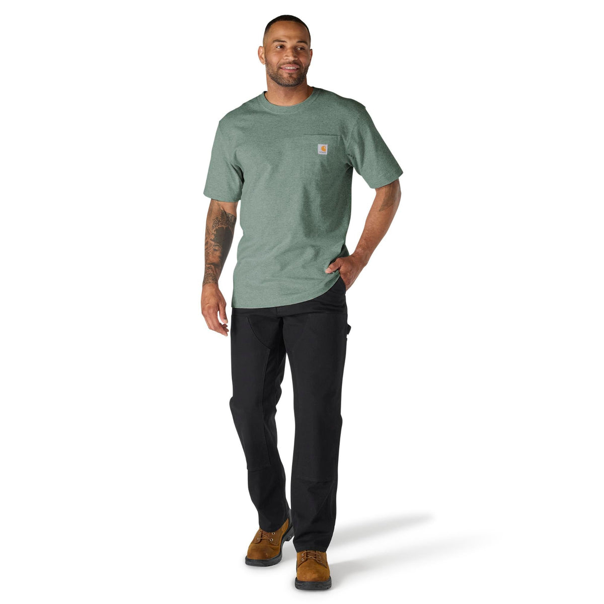 Man wearing a green t-shirt and black pants on a white background