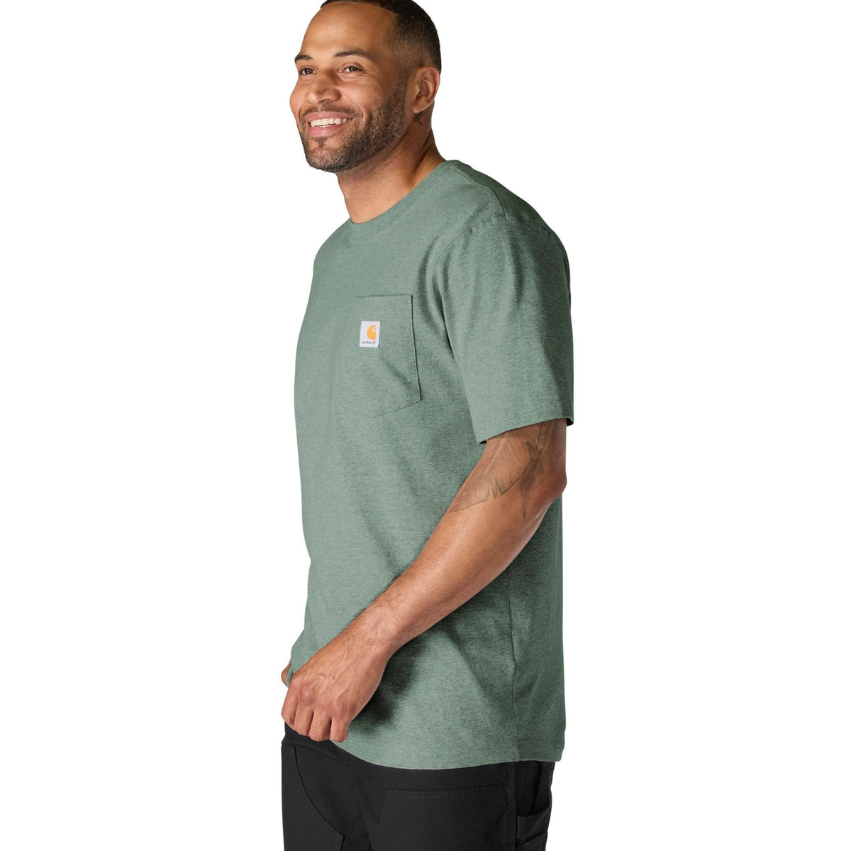 Man wearing a green t-shirt with a pocket on a white background