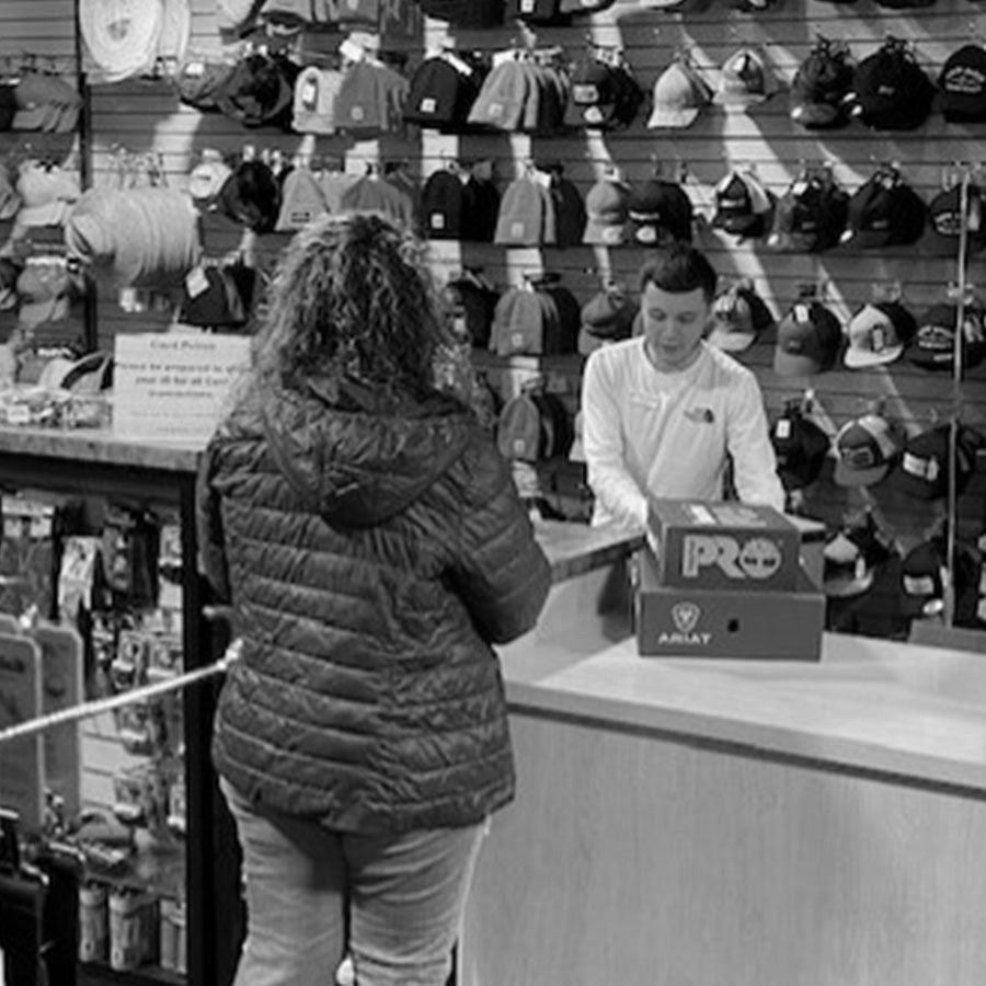 Customer with store associate inside Work World Salinas.